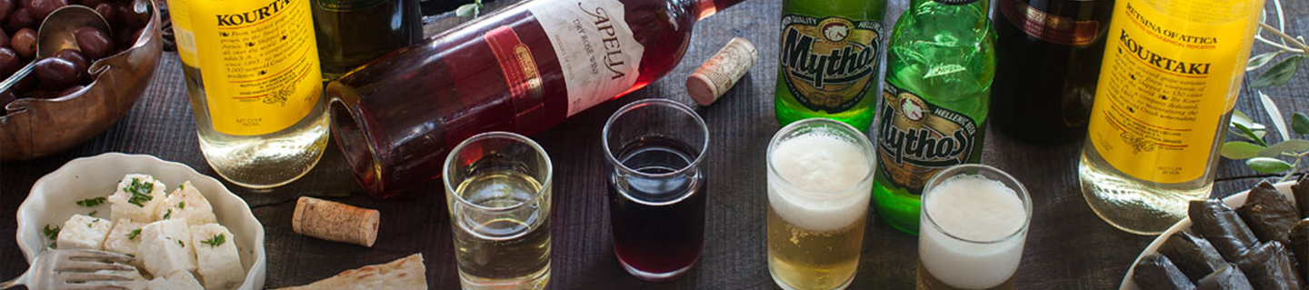 Greek wine, Mythos beer and spirits with mezze on a table